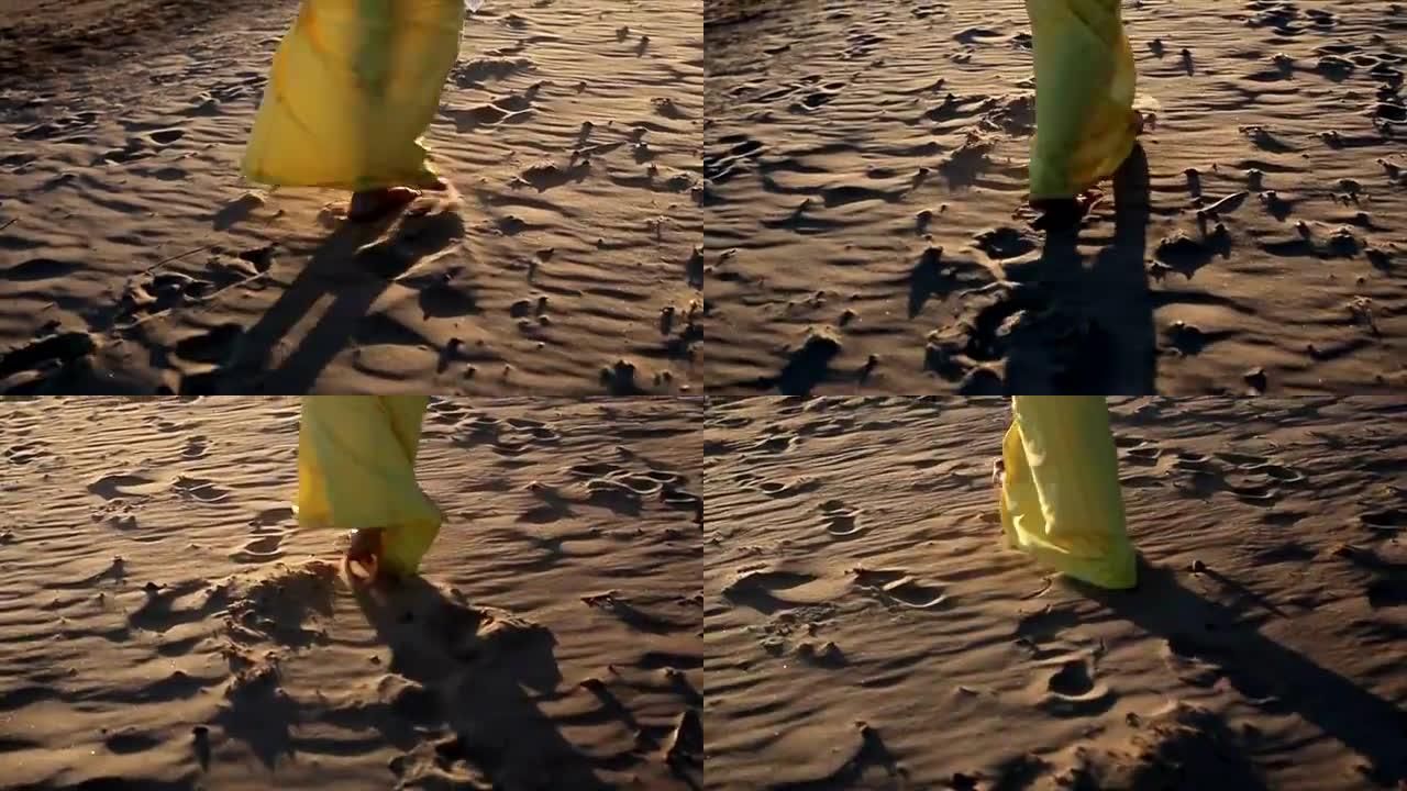 穿着黄色连衣裙的女人在海滩上行走