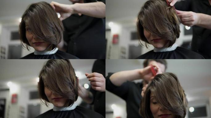 专业美发师，发型师梳理女性客户的头发，并在专业美发沙龙中使用发夹固定发型。美容和护发理念
