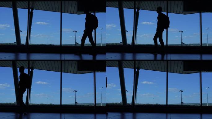 一个背着背包的男人走在机场候机楼