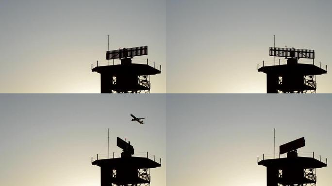 飞机在机场日落时从雷达电信塔上起飞