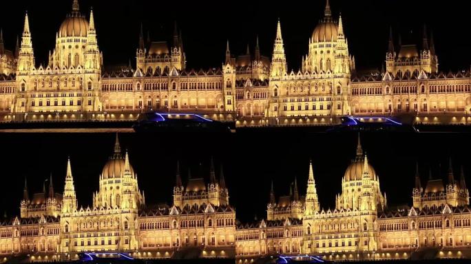 布达佩斯议会之夜。匈牙利议会大楼的夜晚，照明，与一艘游轮驶过多瑙河