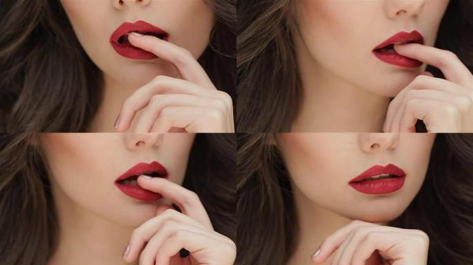 关闭手指在一个年轻女孩的嘴唇上