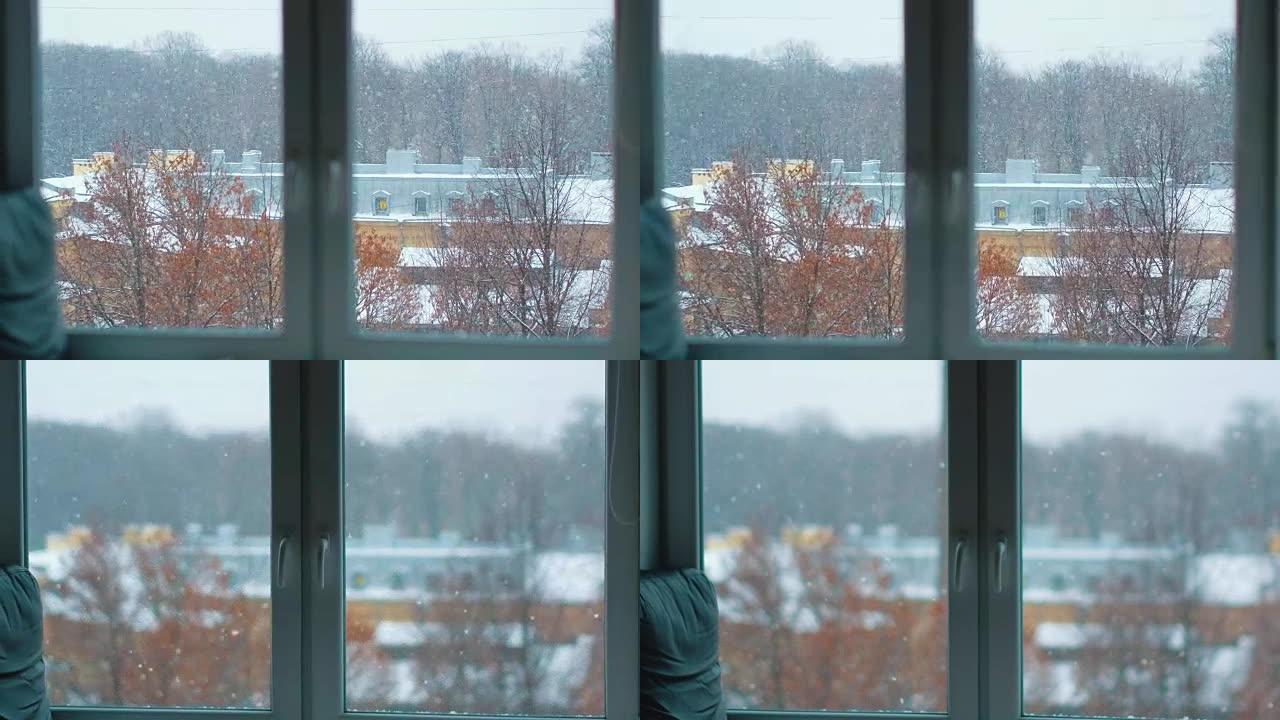从窗户看到冬天的降雪。透过窗户看冬天