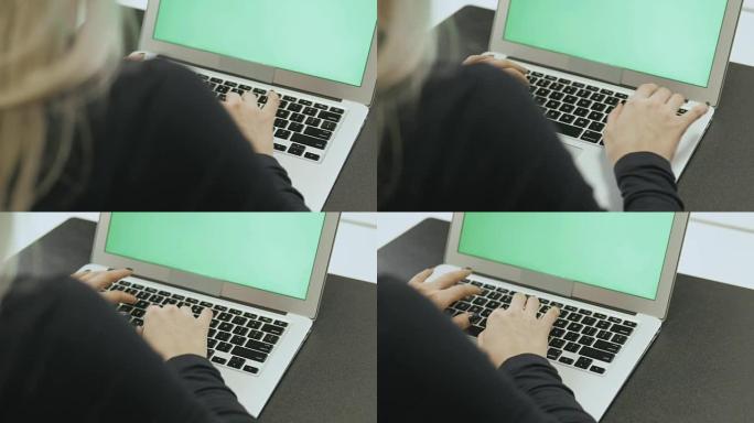 迷人的年轻女子使用带色度键的笔记本电脑