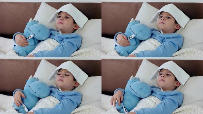 婴儿测量温度电子体温计，多病的样子，嗓子疼的小男孩，脖子上围着围巾的孩子躺在床上，高温