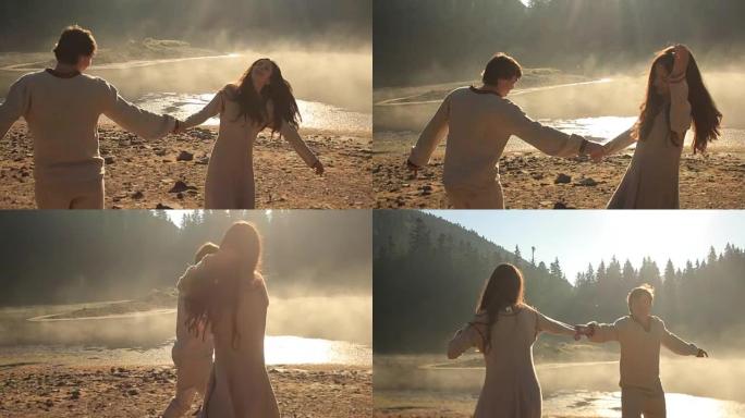 在喀尔巴阡山脉风景如画的锡内维尔湖附近，恋爱中的幸福年轻夫妇。日落时，穿着传统服装的年轻男女在金色的
