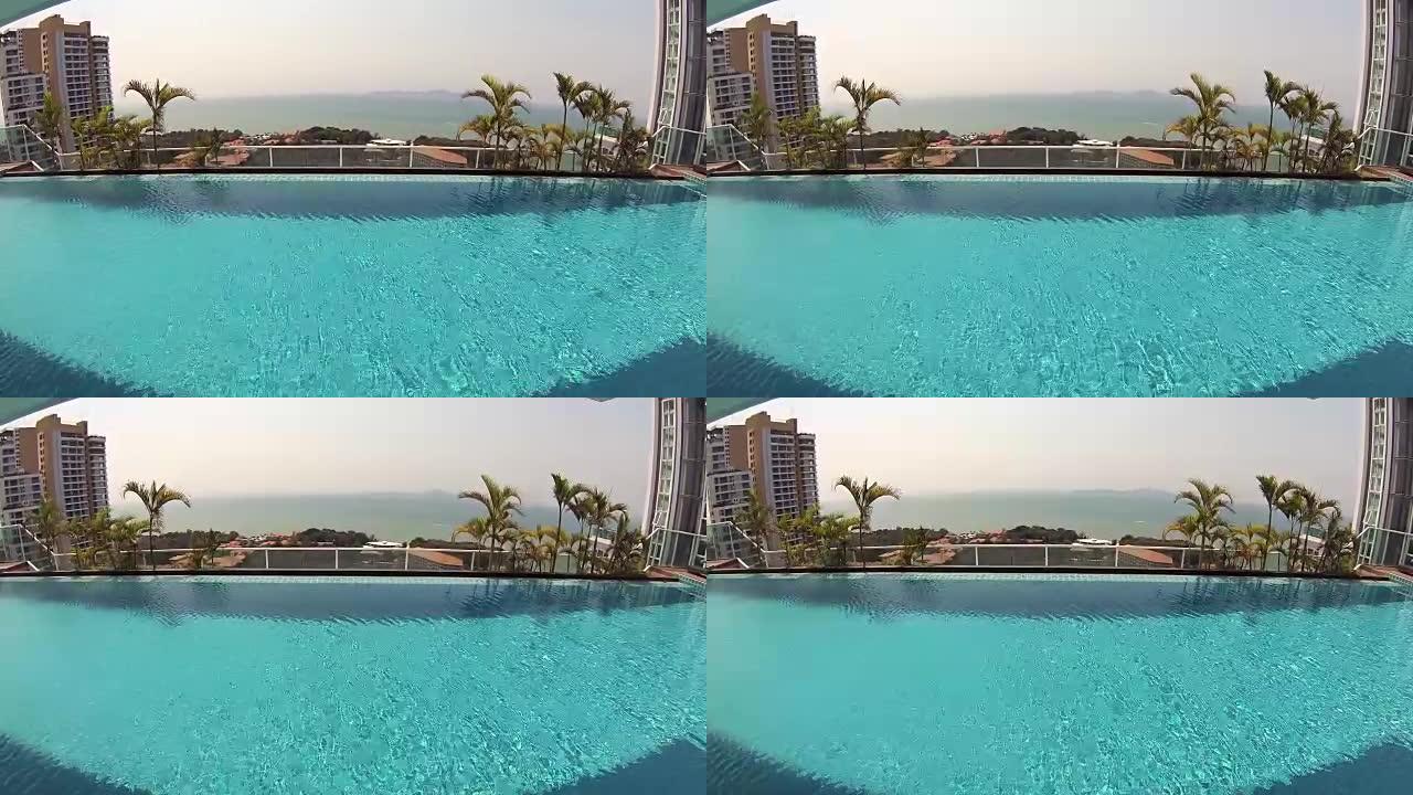 豪华热带酒店美丽清新的蓝色游泳池水。晴天棕榈。动作摄像机
