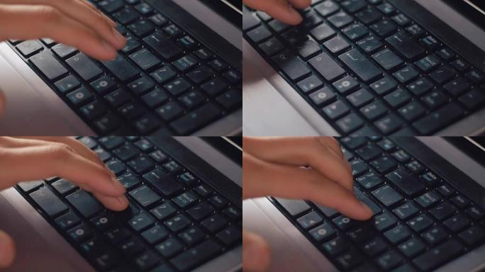 一个年轻人的特写在笔记本电脑键盘上按enter键