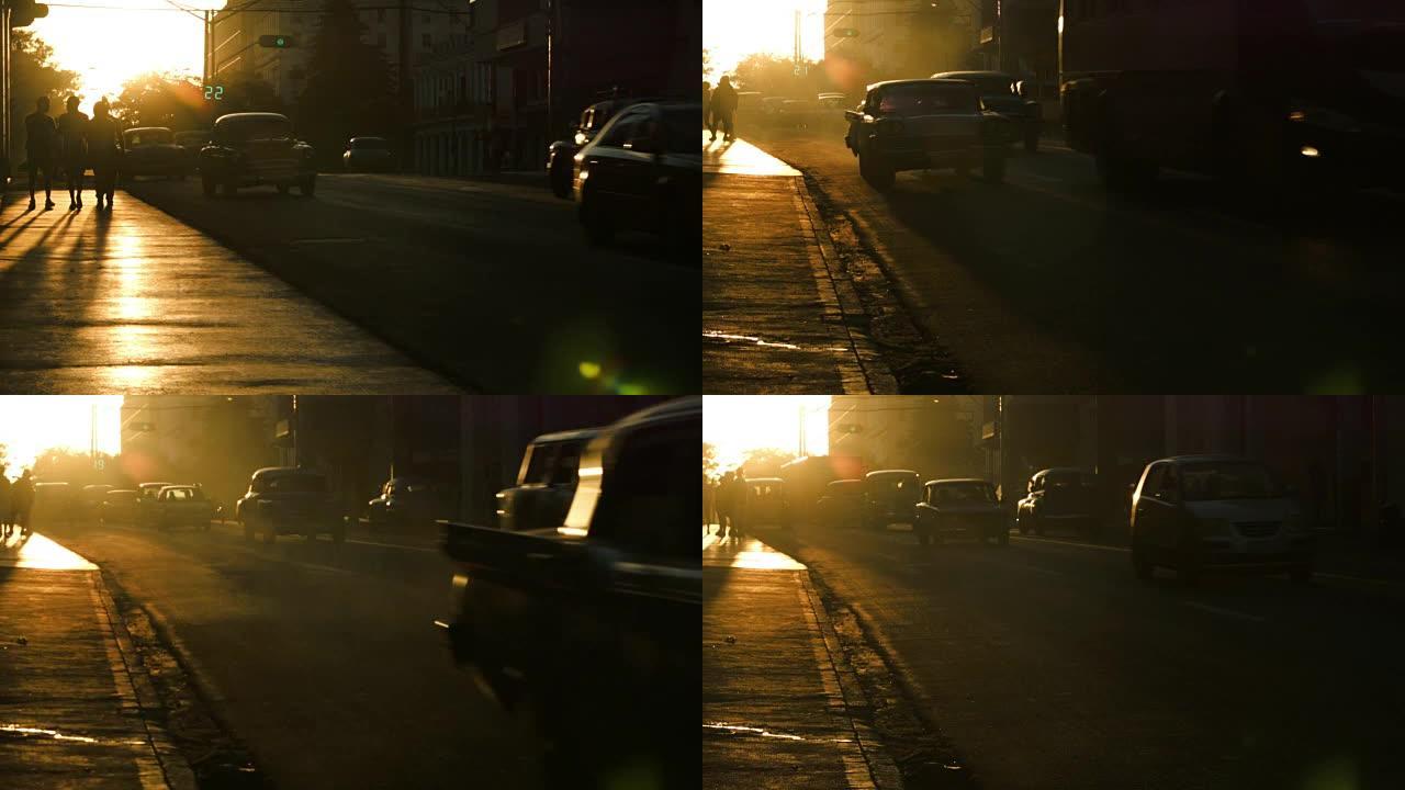 哈瓦那日落中的行人和汽车发光剪影
