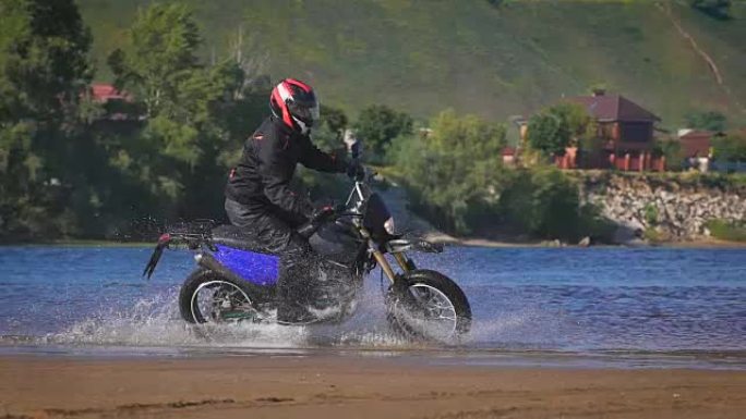 极端驾驶摩托车。一个熟练的骑自行车的人骑在水边