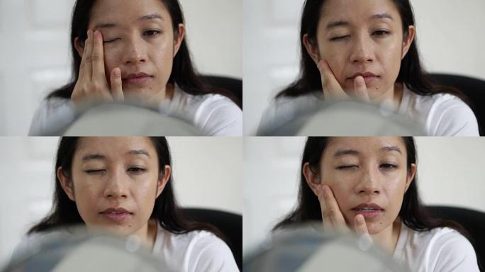 亚洲女性在慢动作化妆前先在脸上涂抹粉底