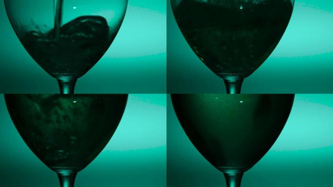 倒入玻璃杯中的白葡萄酒，绿色，慢动作，特写镜头