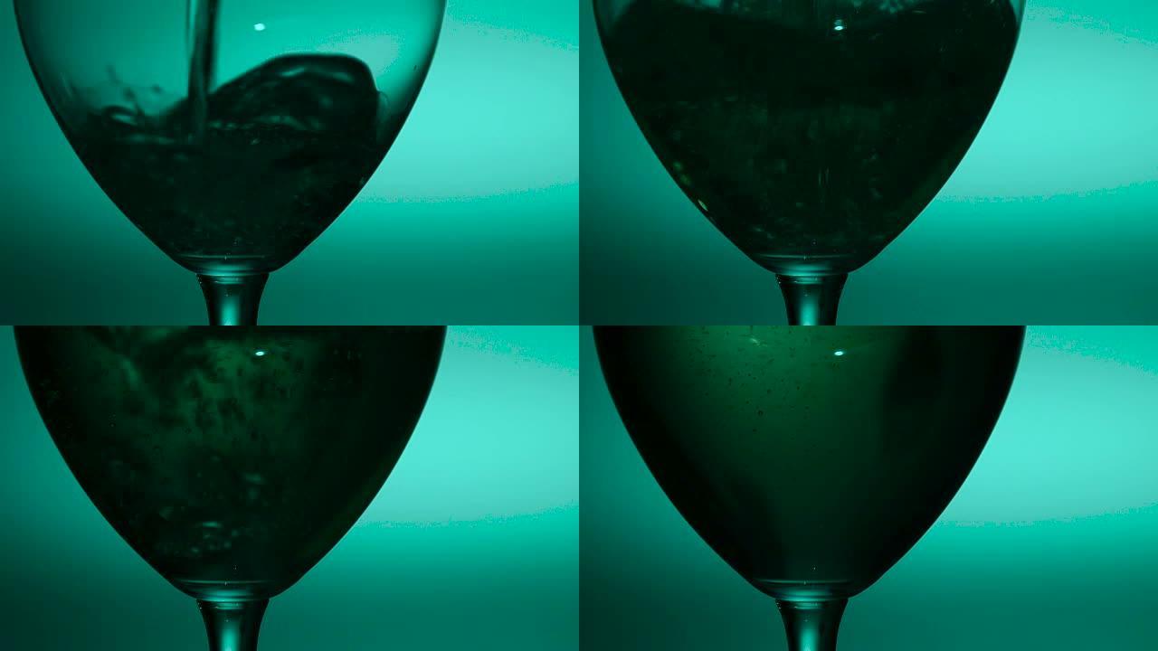倒入玻璃杯中的白葡萄酒，绿色，慢动作，特写镜头