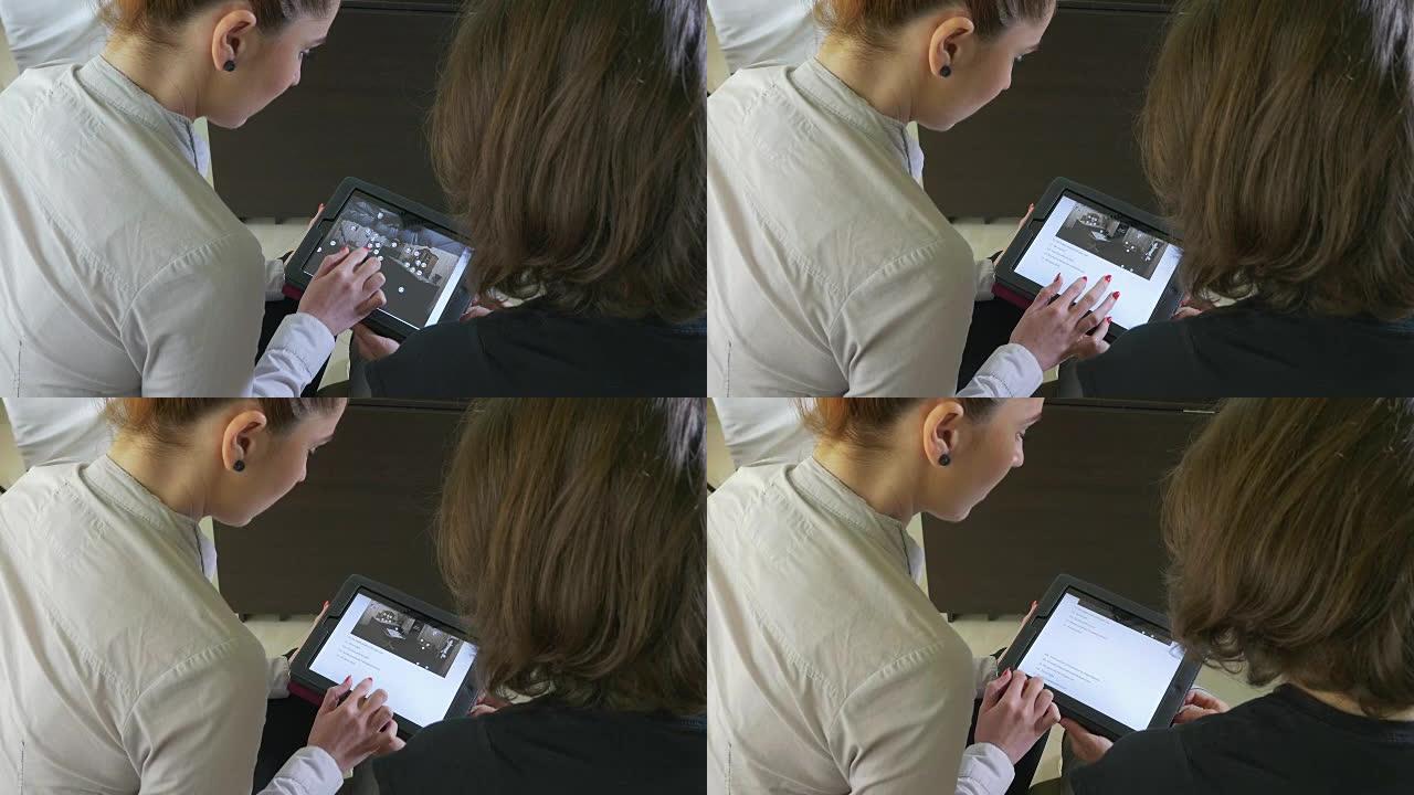 两名商务女性在平板电脑上展示