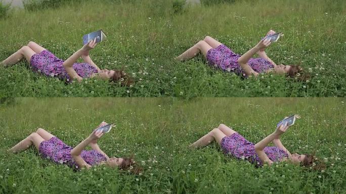 美丽的年轻女子-草地上的学生读本