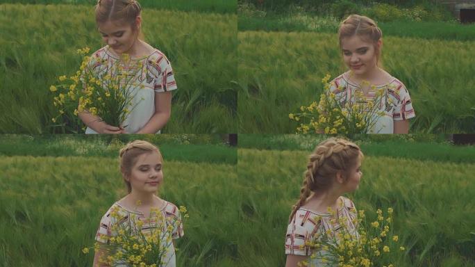 可爱的年轻女孩拿着一束油菜花，在田野里嗅它