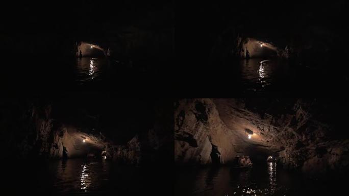 在越南下龙湾的黑暗喀斯特洞穴中航行
