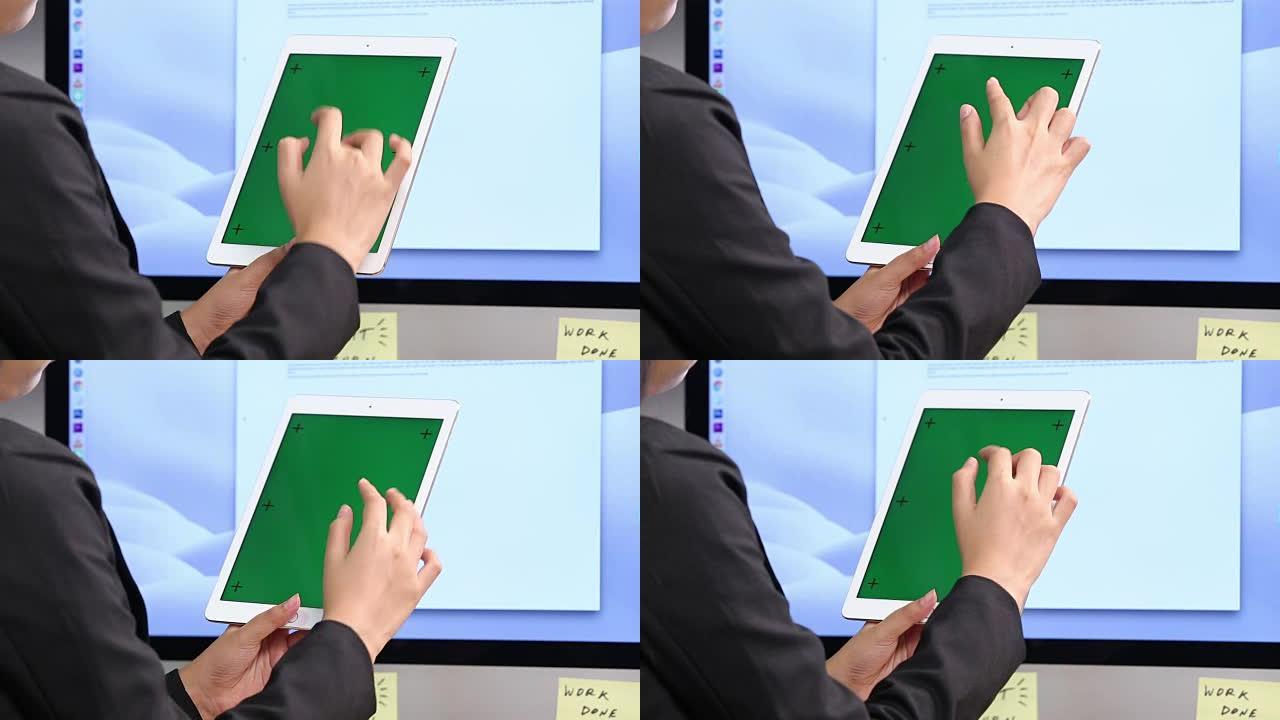 手指在绿屏平板电脑和大显示器电脑前，概念触摸屏商业跟踪运动放置内容