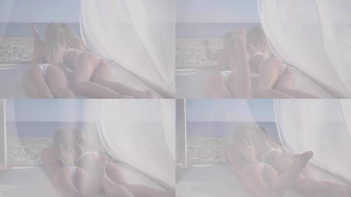 优雅女孩的性感屁股，热带海滩上平房的白色窗帘的美丽景色，海滩上的女朋友享受日光浴