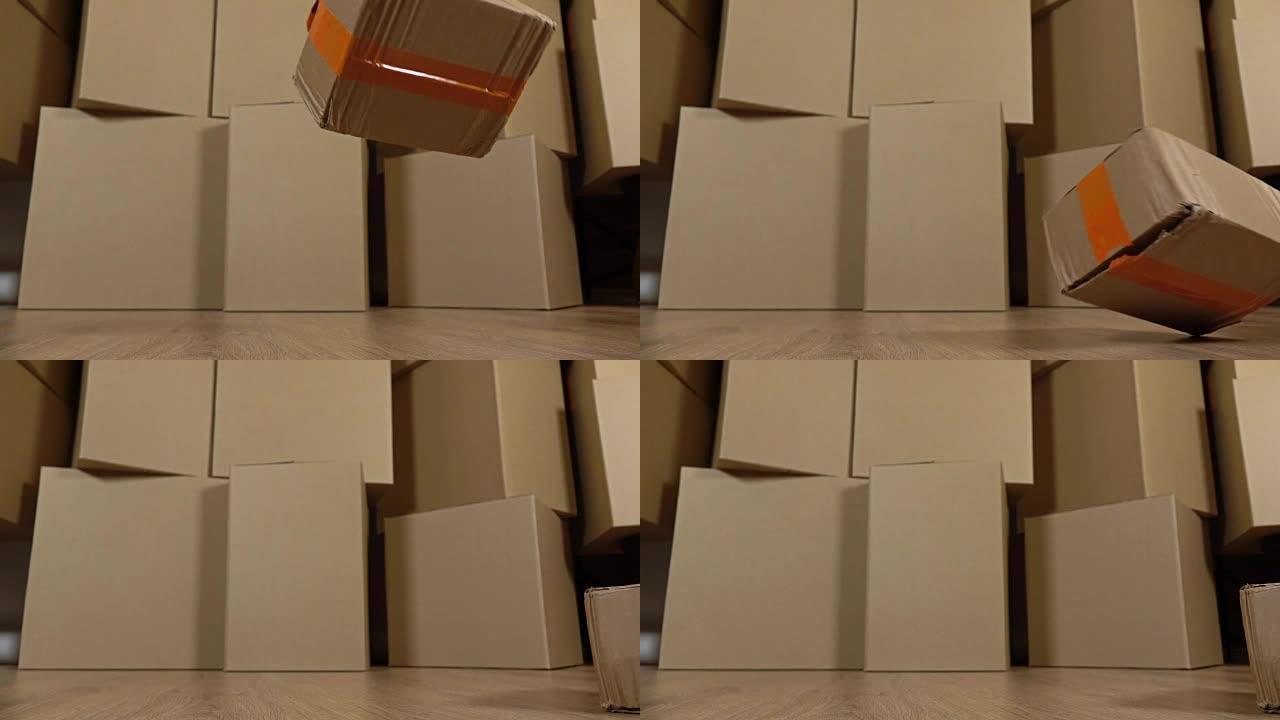 掉落在地板上的损坏包裹。棕色纸箱背景。缺陷和不专业的工作概念。超级慢动作工作室拍摄