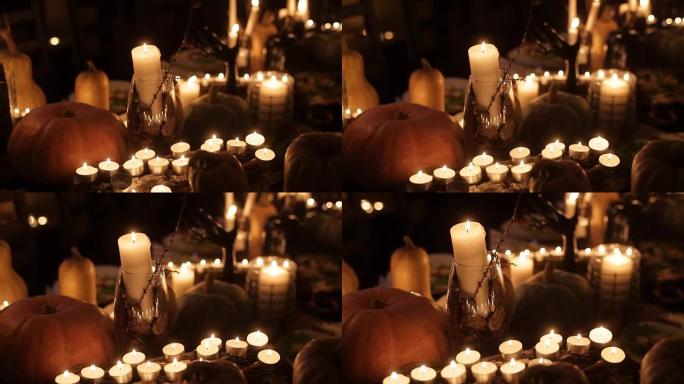 万圣节节日餐桌上有蜡烛和南瓜