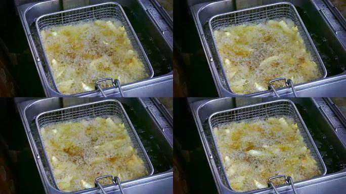 4k镜头，薯条的俯视图在厨房里油炸。