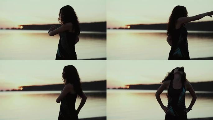 女孩在日落时训练。转动身体，温暖的手