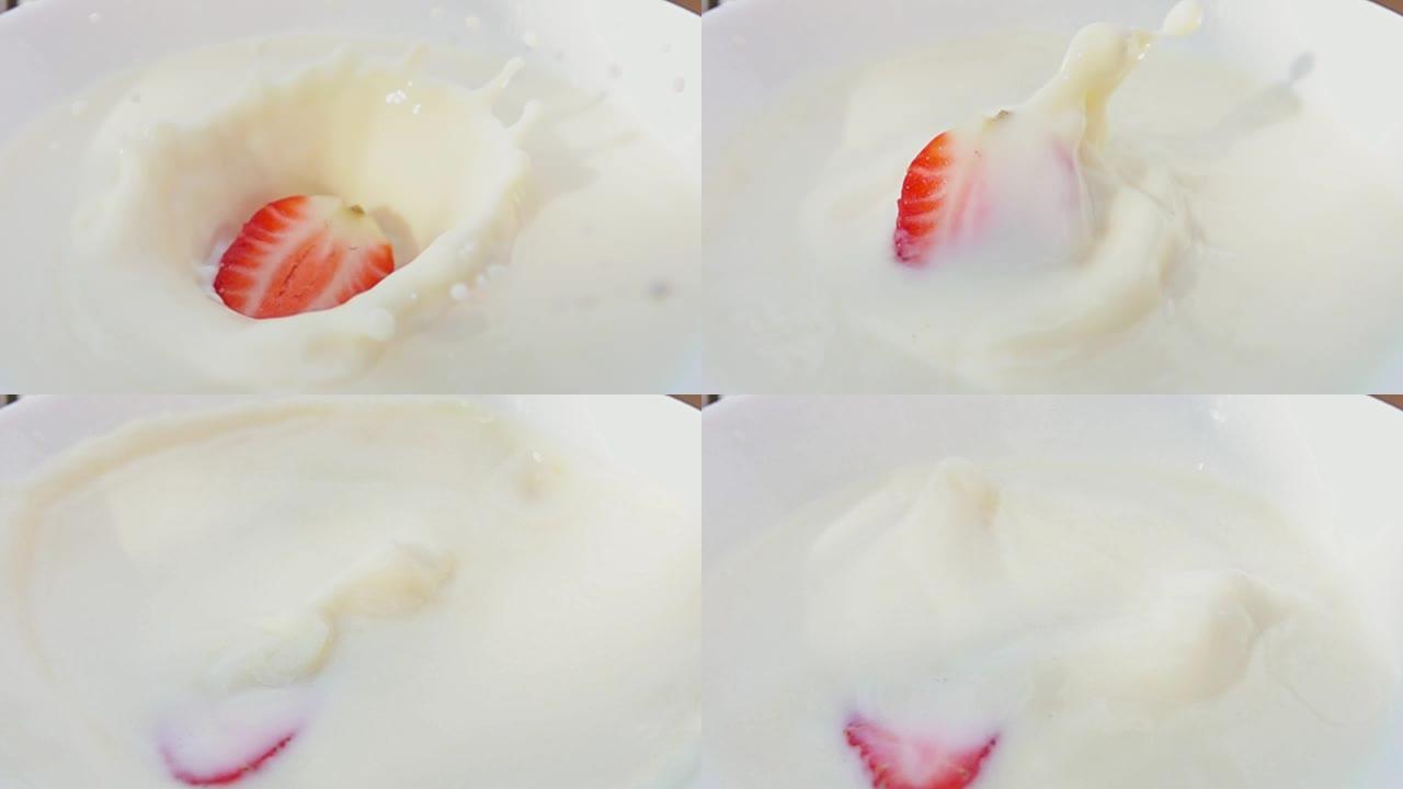 一半的草莓掉在一个装有奶油的碗里