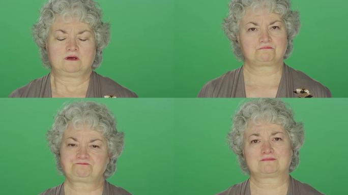 在绿屏工作室背景上，看起来沮丧的老女人