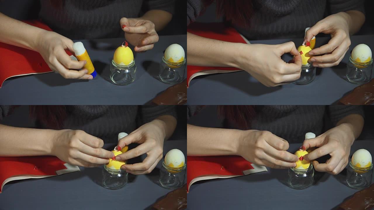用手在灰色桌子上从贝壳上制作复活节鸡。