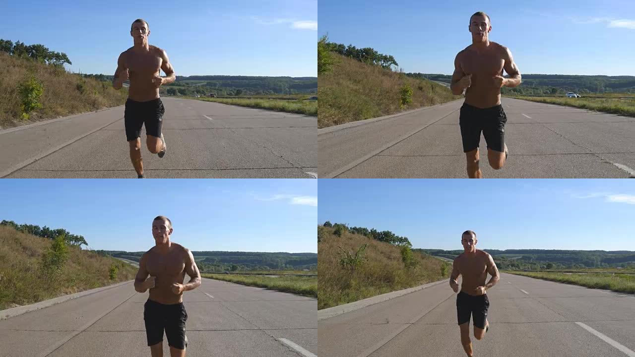 短跑运动员在高速公路上慢跑。男性运动运动员在夏季进行户外训练。年轻强壮的肌肉发达的家伙在锻炼期间在乡
