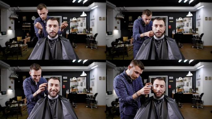 大胡子的潮人坐在理发店里，上面覆盖着黑色的peignoir。理发师穿着便服站在顾客身后，用理发推子和