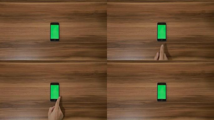 智能手机在木桌背景上滑动左手手势。垂直