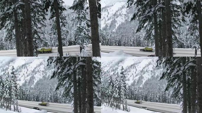 用汽车在积雪覆盖的山路上扫雪机的吊臂起重机拍摄