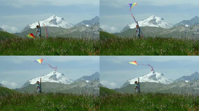 在高山上放风筝的小男孩。