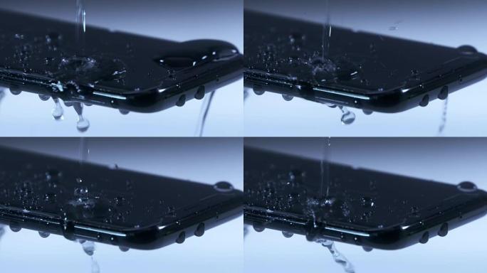 水滴以慢动作落在手机屏幕上。