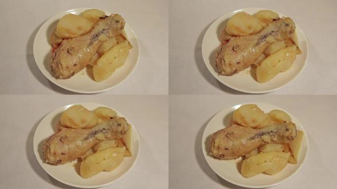 鸡腿配土豆放在白盘上