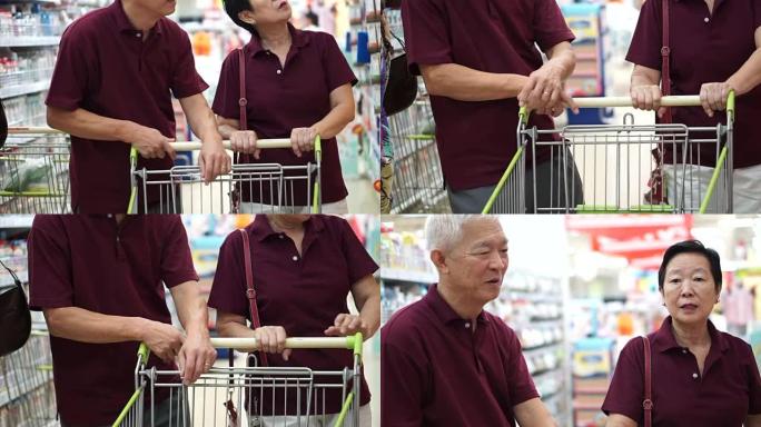 亚洲老年夫妇用购物车在超市购物