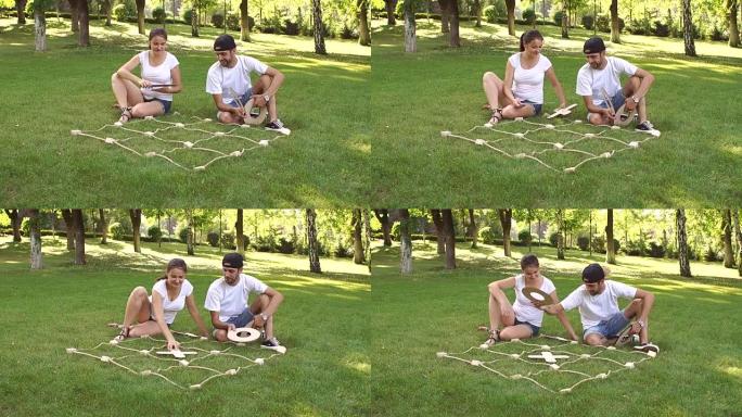 两个朋友在公园玩大井字游戏。