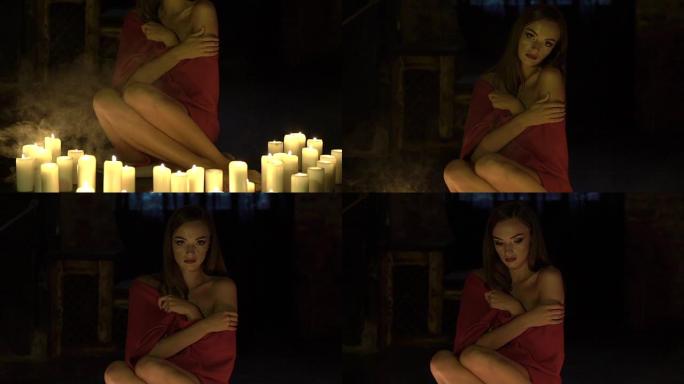 聪明的独处女孩坐在地板上，靠近蜡烛。慢慢地