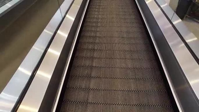 国际机场航站楼自动扶梯的长走道，移动视点