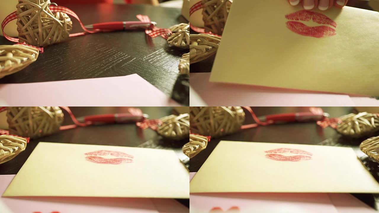女孩手放下一个信封，上面贴有红色口红邮票。特写