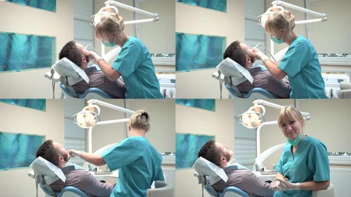 女牙医钻牙齿，看着镜头。滑块镜头，对。