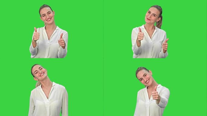快乐兴奋的女人表现出认可的手势拇指向上并在绿色屏幕上微笑，色度键