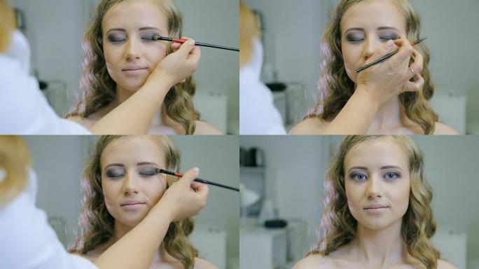 专业化妆师在金发模特眼睑上涂色调粉做眼影。