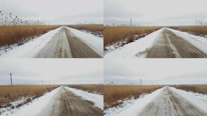 在积雪覆盖的孤独乡村道路上行驶。
