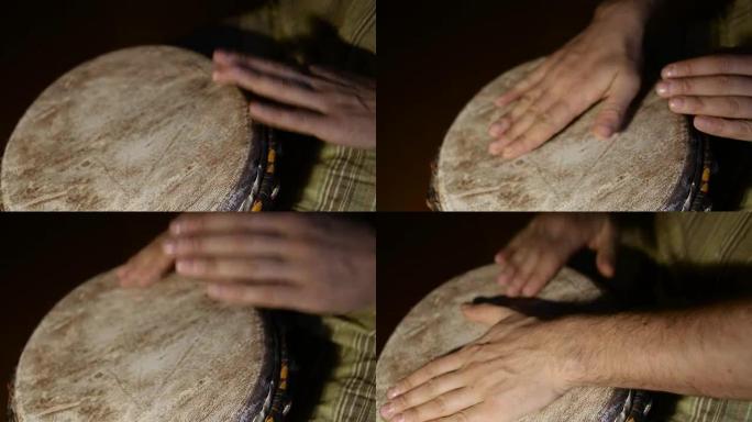 人的手在非洲皮肤覆盖的手鼓上敲击。