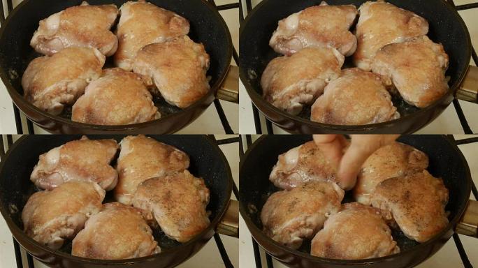 煎锅里的鸡大腿。