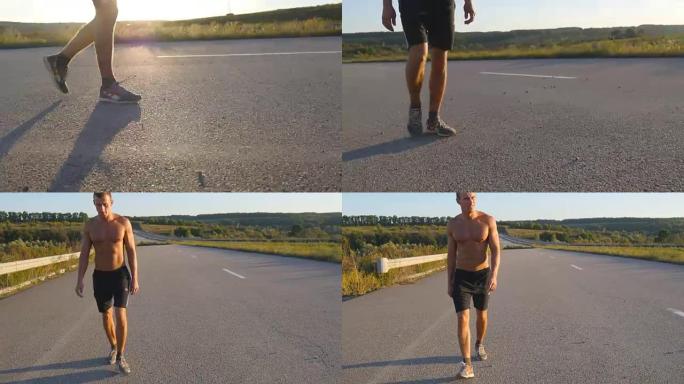 男性的脚在日落时在乡村道路上行走，靠近。年轻人正走在一条空旷的乡间小路上。穿过阳光照射的人。小男孩的