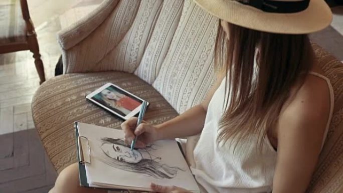 年轻女子在咖啡馆用铅笔画肖像